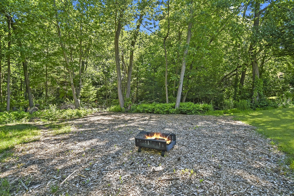 187 Eaton Road Framingham, MA 01701 - Photo 41 of 41 a wooden bench sitting in the middle of a field