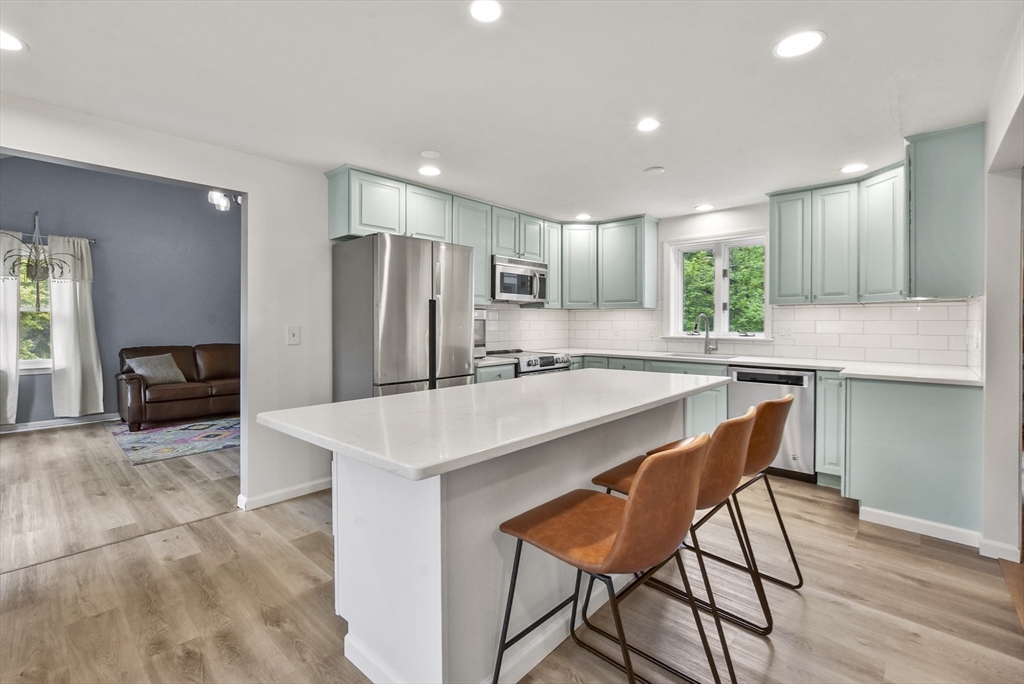 187 Eaton Road Framingham, MA 01701 - Photo 6 of 41 a kitchen with stainless steel appliances a table and chairs in it