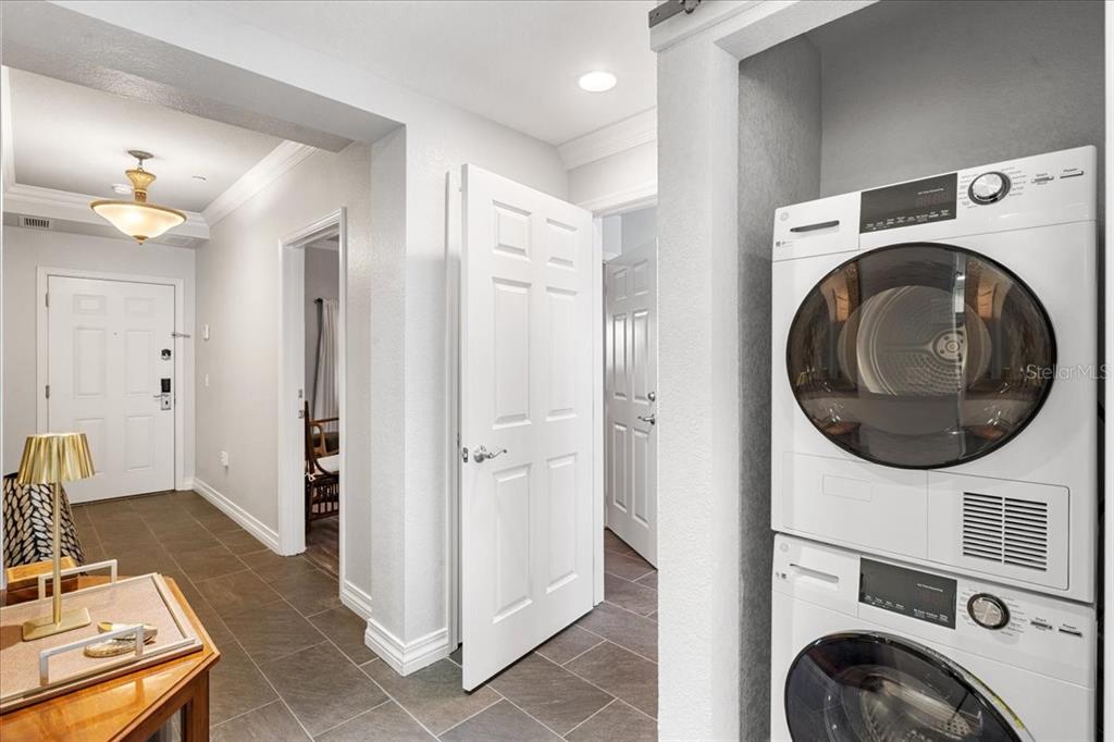 7658 Whisper Way, Unit 402 Reunion, FL 34747 - Photo 12 of 31 a view of a kitchen with washer and dryer