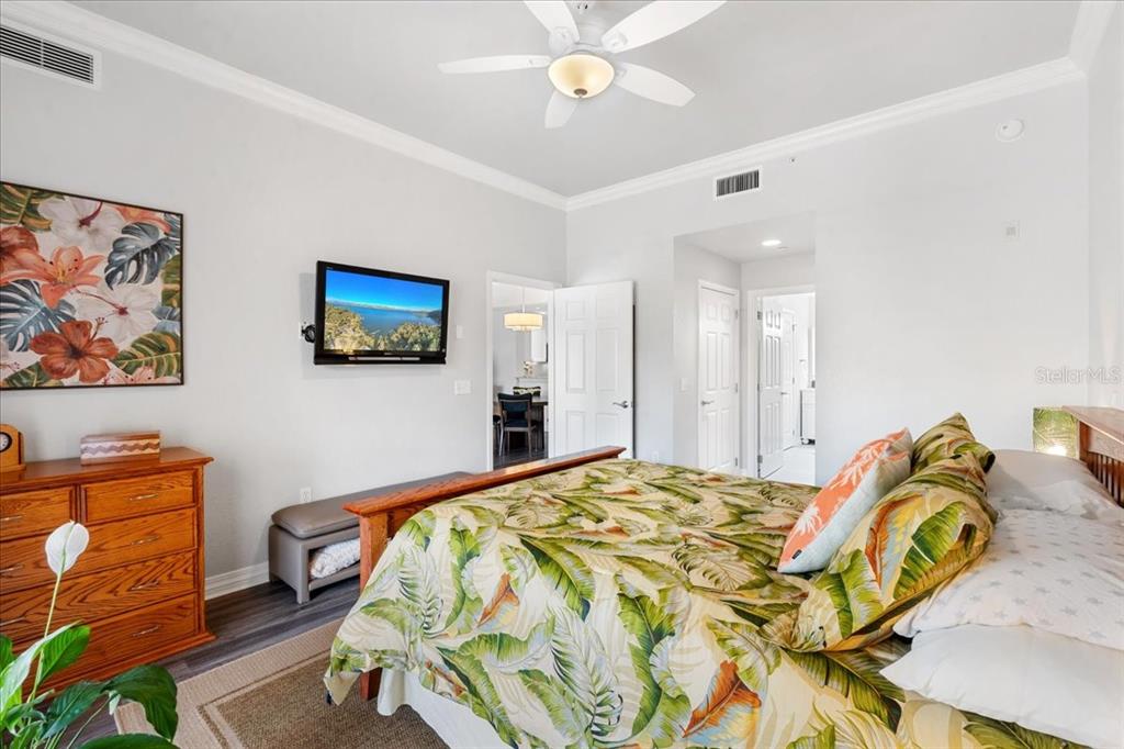 7658 Whisper Way, Unit 402 Reunion, FL 34747 - Photo 14 of 31 a bedroom with a bed and dresser