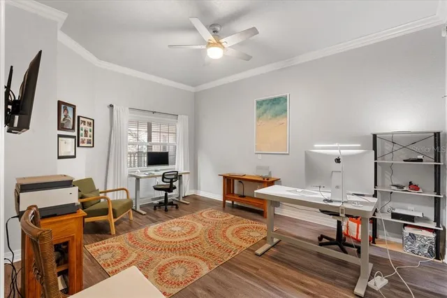 a view of a livingroom with workspace and a window