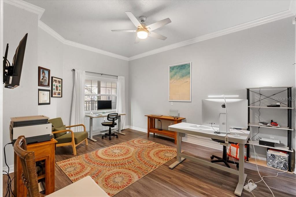 7658 Whisper Way, Unit 402 Reunion, FL 34747 - Photo 20 of 31 a living room with furniture a rug and a chandelier