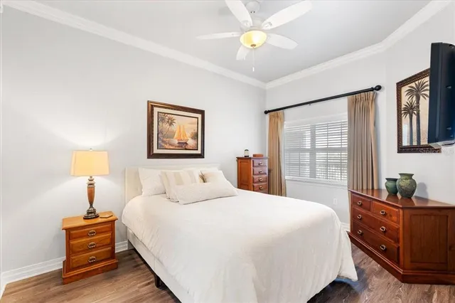 a bedroom with a bed and a lamp on dresser