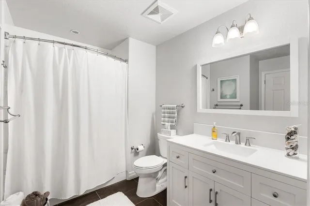 a view of a hallway with wooden floor and cabinet