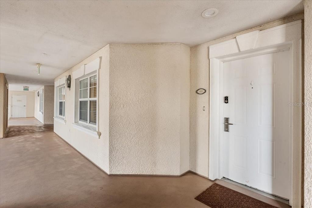 7658 Whisper Way, Unit 402 Reunion, FL 34747 - Photo 26 of 31 a view of a hallway with wooden floor and cabinet