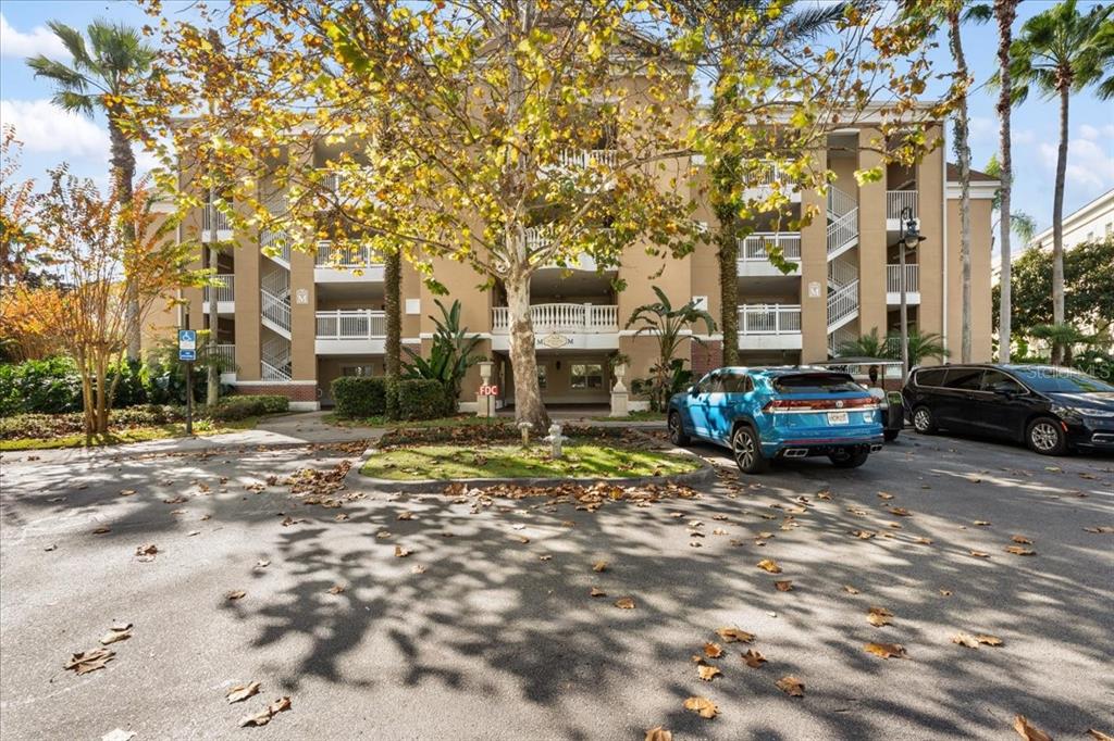 7658 Whisper Way, Unit 402 Reunion, FL 34747 - Photo 28 of 31 a view of a parked cars in front of a building