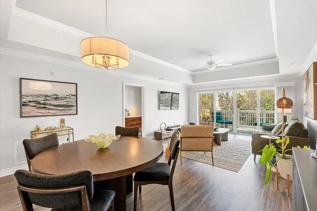 a living room with furniture a chandelier and a large window
