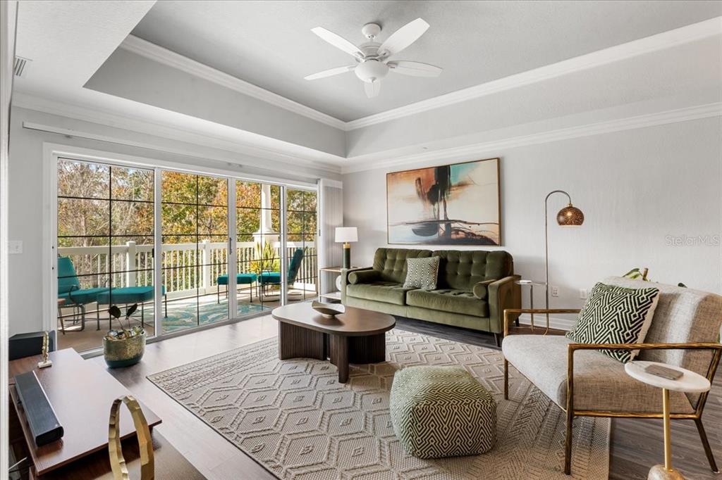 7658 Whisper Way, Unit 402 Reunion, FL 34747 - Photo 7 of 31 a living room with furniture and a large window