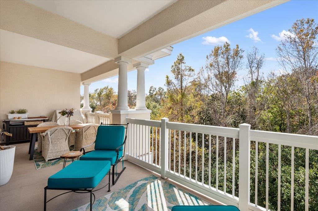 7658 Whisper Way, Unit 402 Reunion, FL 34747 - Photo 8 of 31 a balcony with furniture and a view of lake