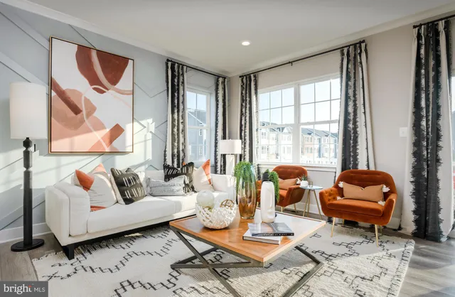a living room with furniture and a floor to ceiling window