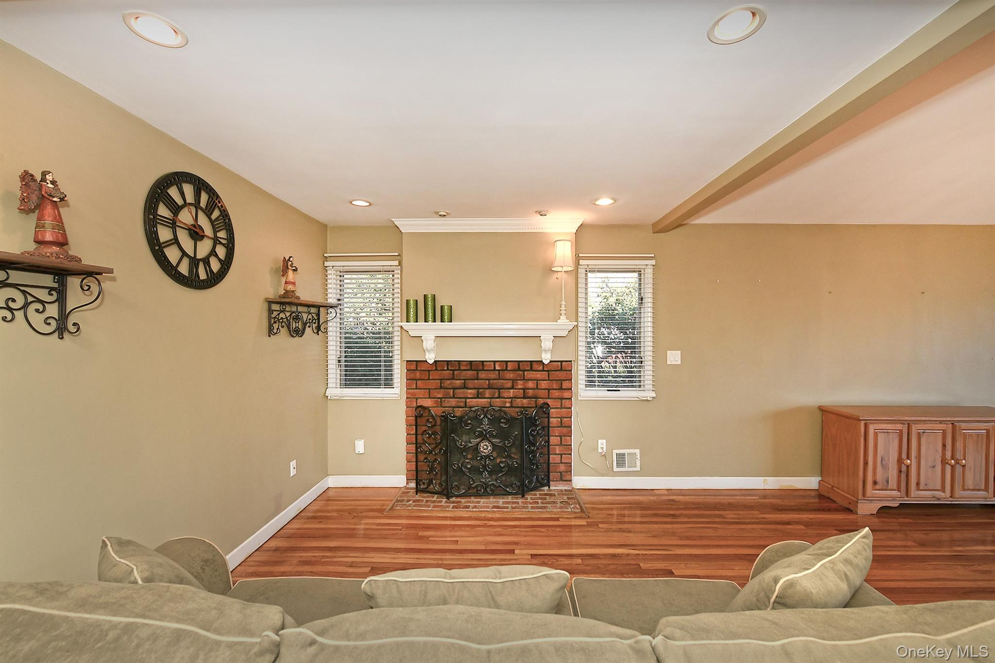 122 Miller Road Hicksville, NY 11801 - Photo 10 of 27 Living area with wood finished floors, a brick fireplace, and recessed lighting