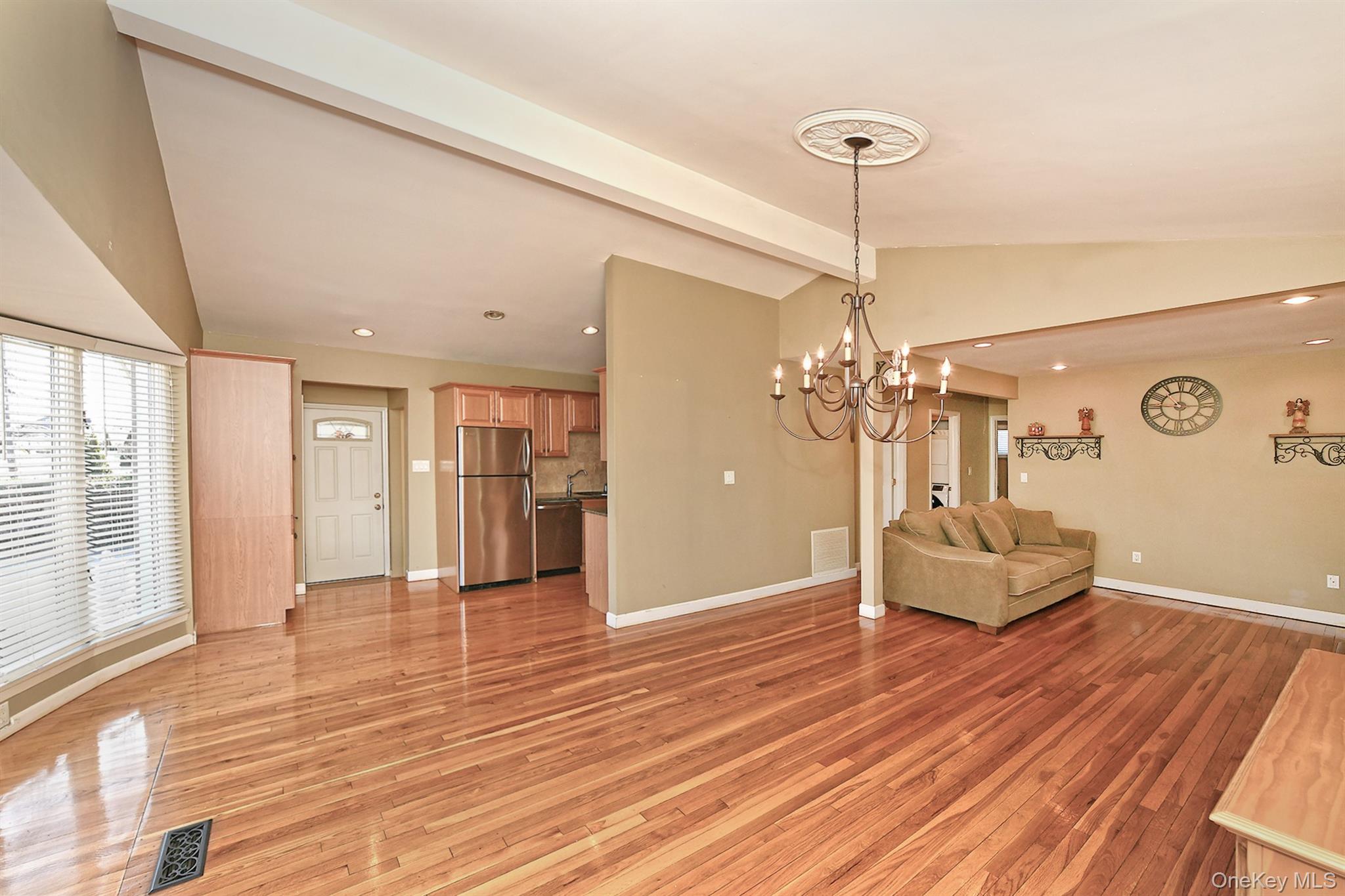 122 Miller Road Hicksville, NY 11801 - Photo 12 of 27 Living room featuring a chandelier, light wood flooring, and recessed lighting