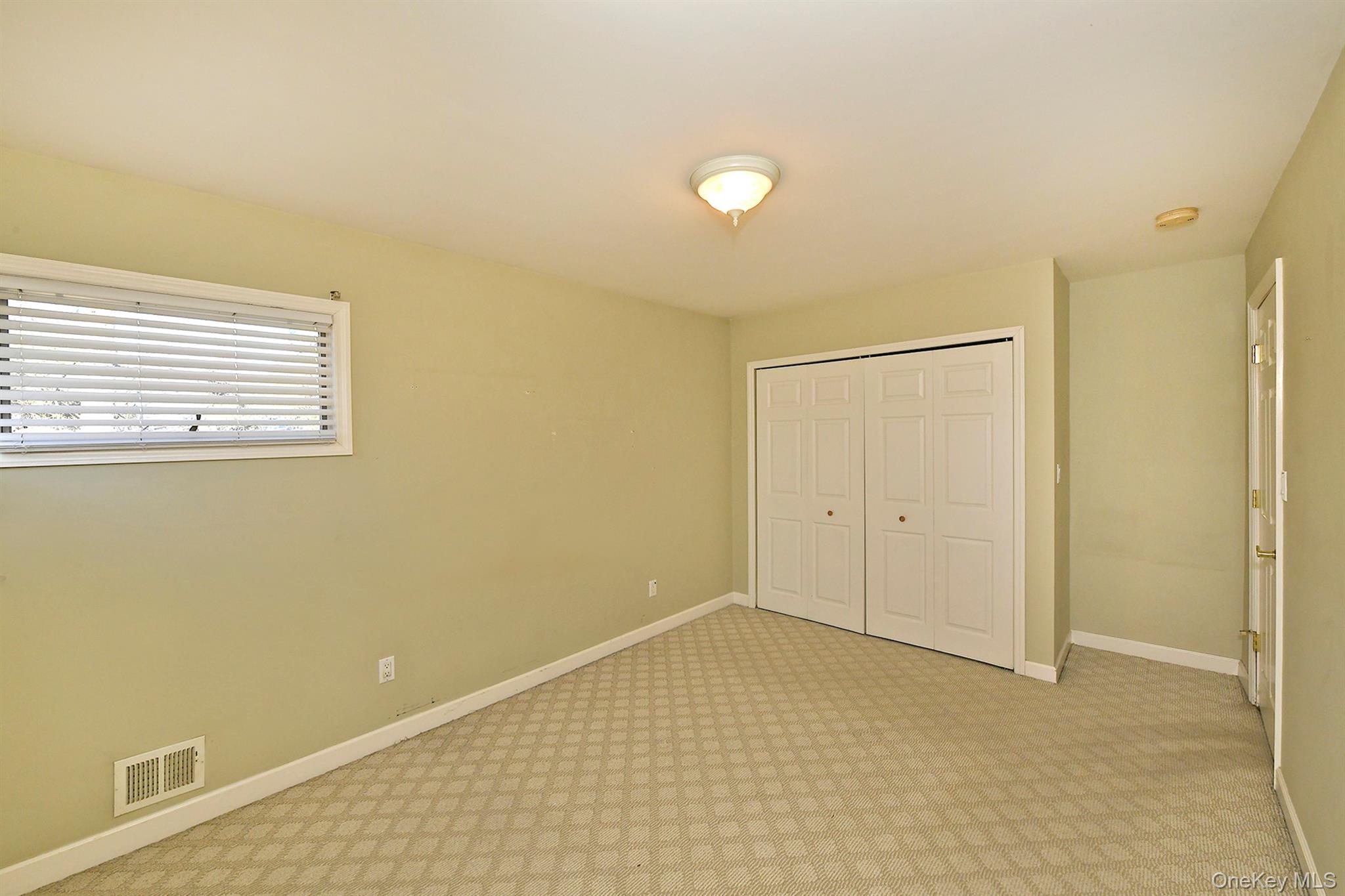 122 Miller Road Hicksville, NY 11801 - Photo 17 of 27 Unfurnished bedroom with a closet and light colored carpet