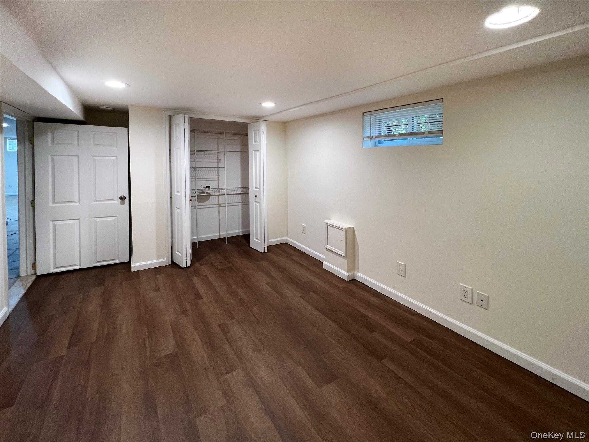 122 Miller Road Hicksville, NY 11801 - Photo 20 of 27 Unfurnished bedroom featuring dark wood-style flooring and recessed lighting