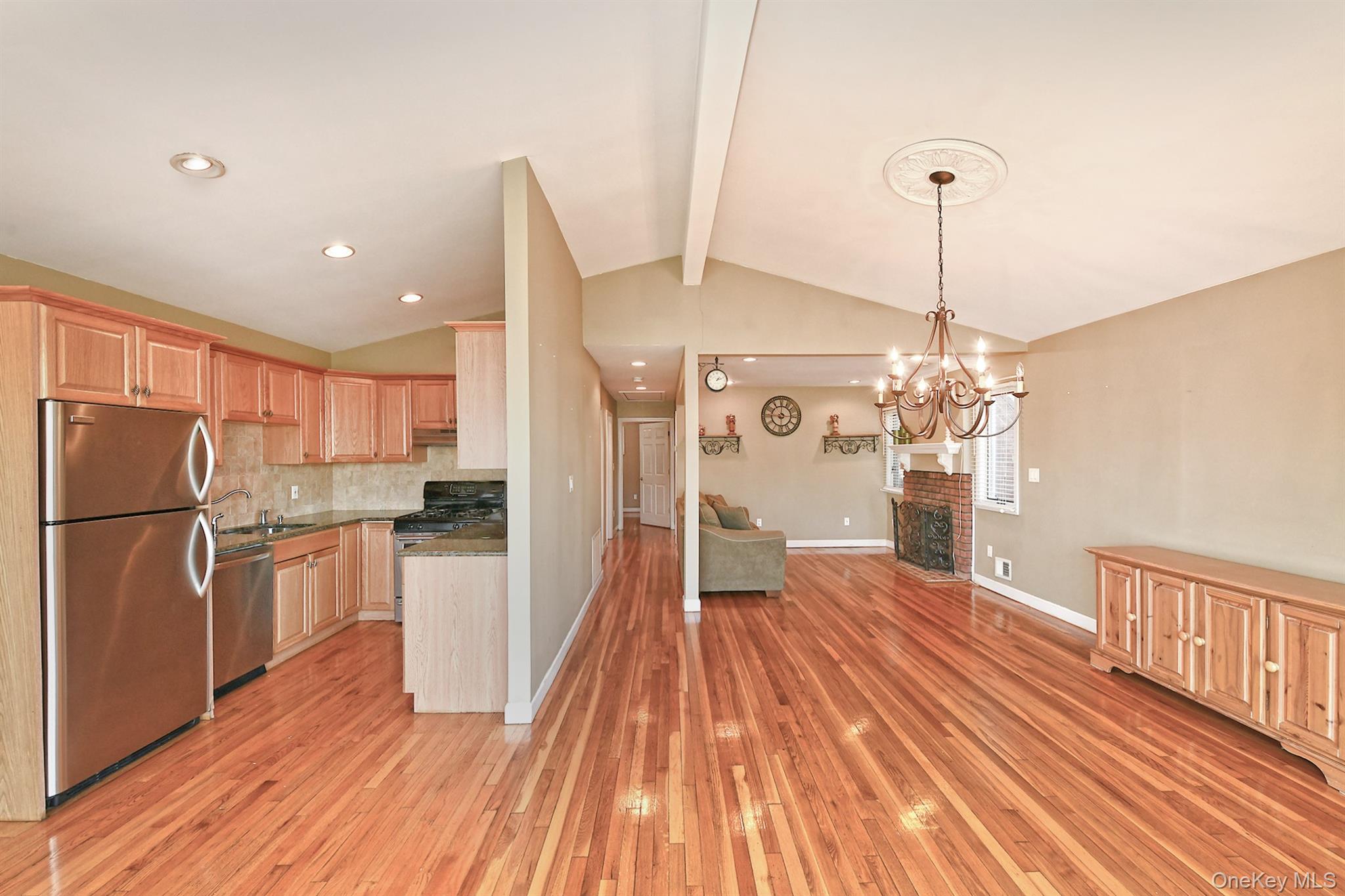 122 Miller Road Hicksville, NY 11801 - Photo 27 of 27 Kitchen with stainless steel appliances, open floor plan, light wood-type flooring, decorative backsplash, and decorative light fixtures