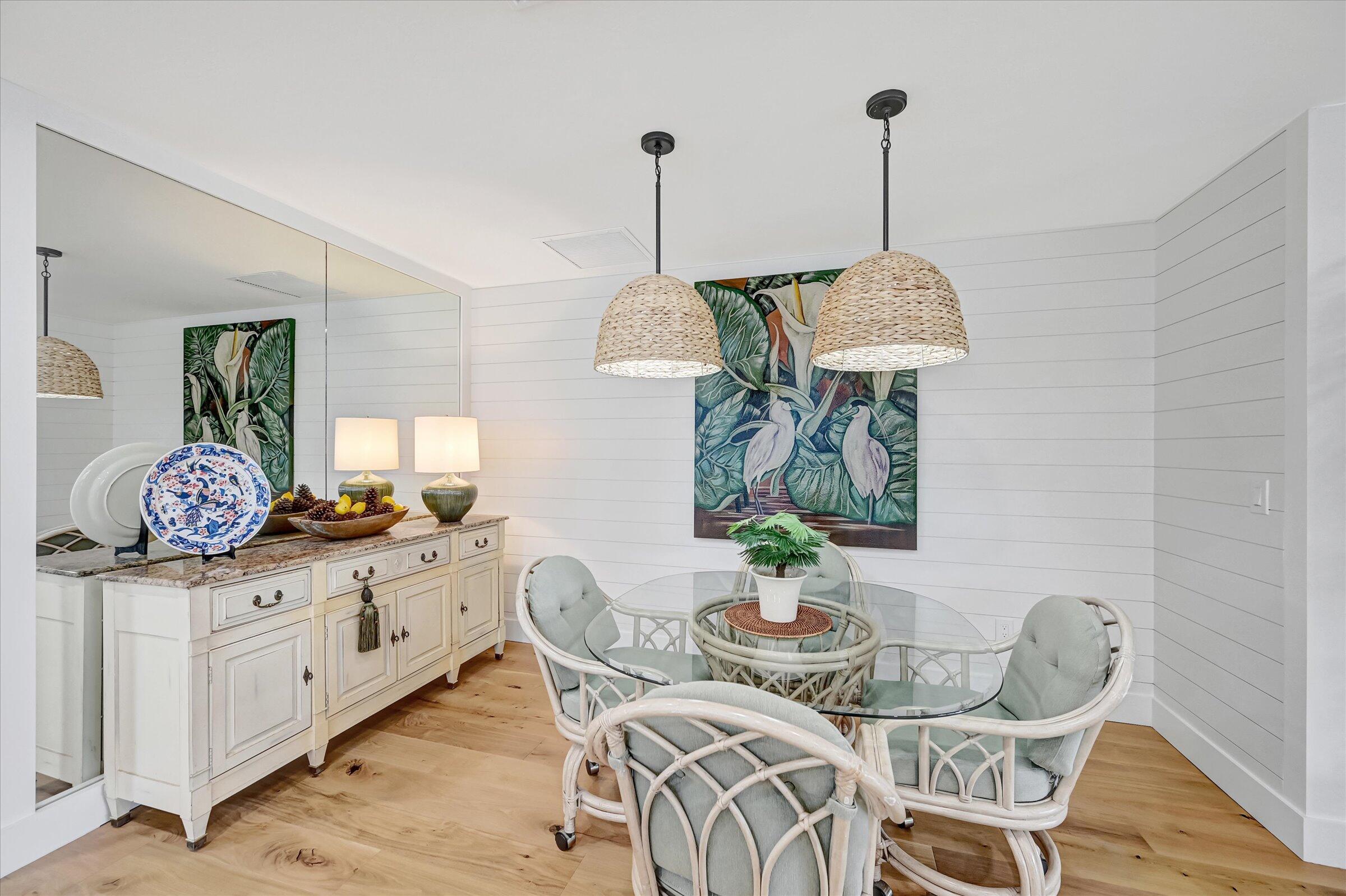 535 Augusta Boulevard, Unit 4 Naples, FL 34113 - Photo 19 of 44 a view of a dining room with furniture wooden floor and chandelier