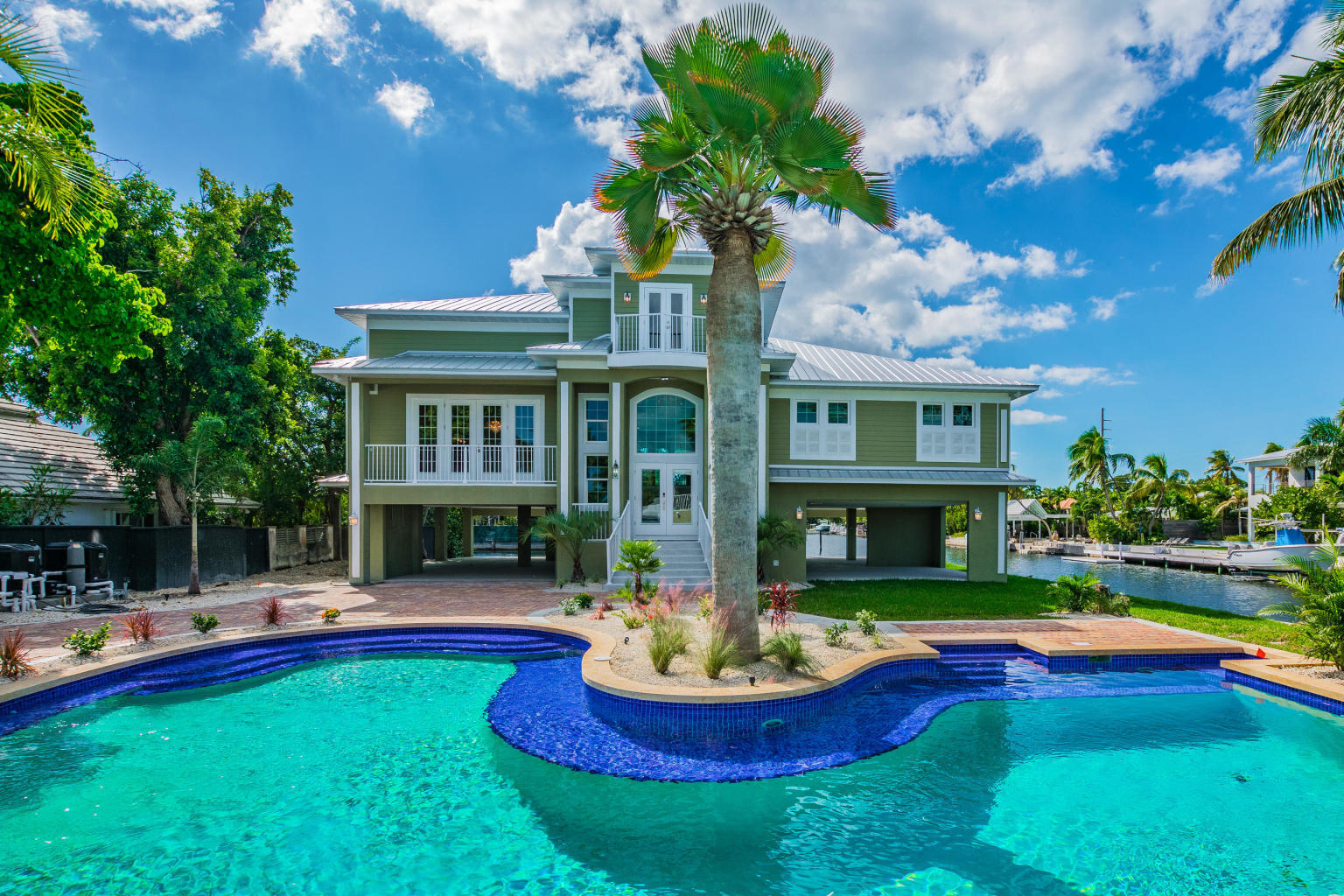 2 Go Lane Key West, FL 33040 - Photo 2 of 42 a front view of a house with swimming pool and porch with furniture