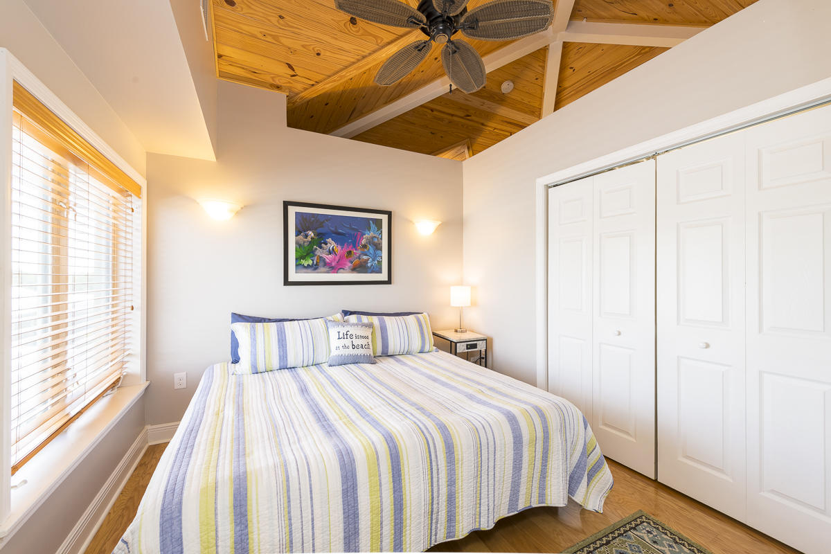 2 Go Lane Key West, FL 33040 - Photo 34 of 42 a bedroom with a bed and wooden floor