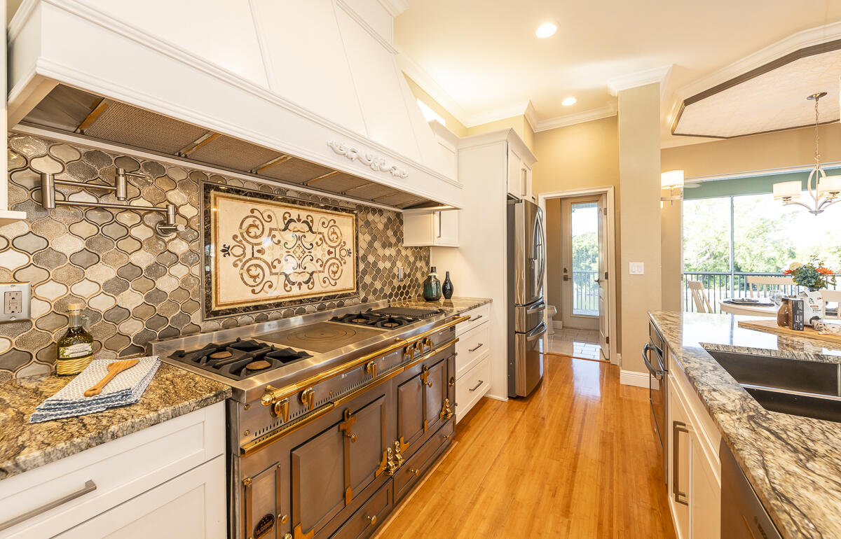 2 Go Lane Key West, FL 33040 - Photo 10 of 42 a kitchen with stainless steel appliances a stove a sink and wooden cabinets