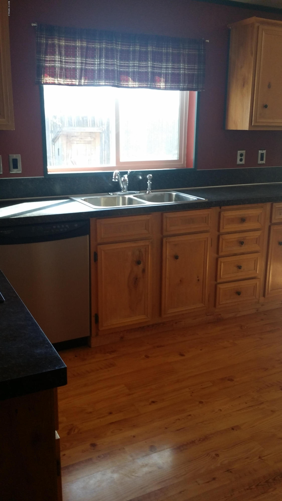 2861 Independence Road Outlook, WA 98938 - Photo 11 of 35 a kitchen with granite countertop wooden cabinets a sink and dishwasher