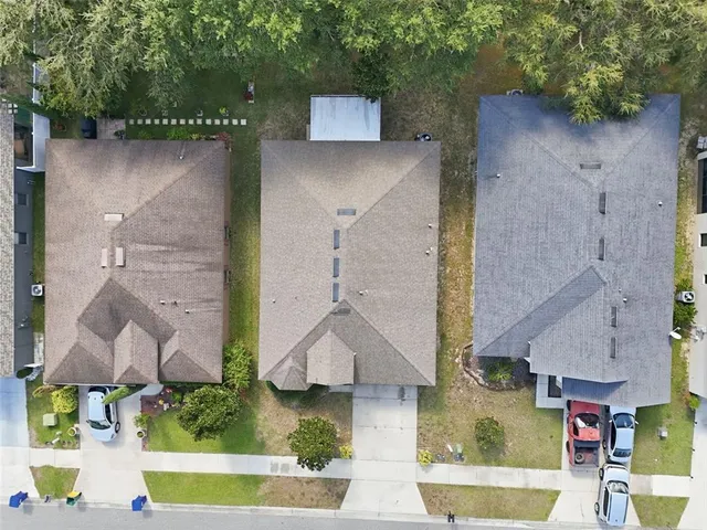 an aerial view of houses with outdoor space