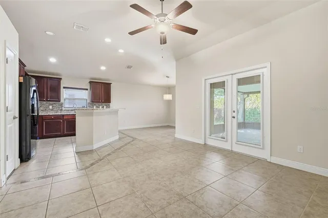 a view of kitchen with refrigerator and microwave