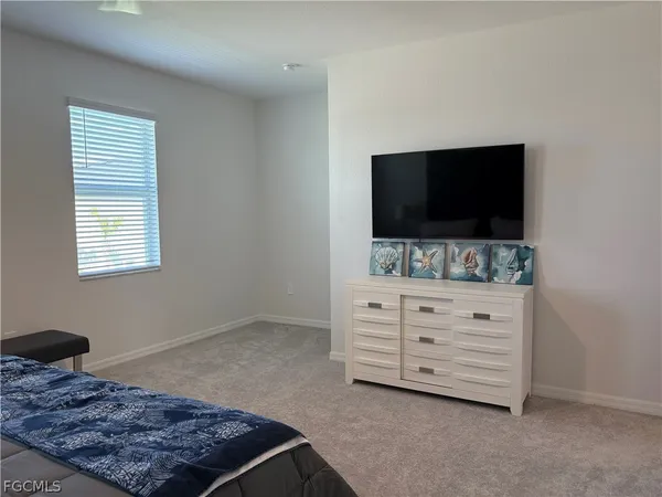 a living room with furniture and flat screen tv