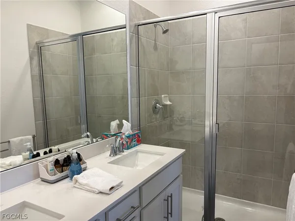 a bathroom with a sink vanity granite and a mirror