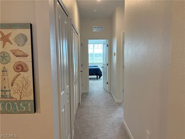 a view of a hallway to rooms