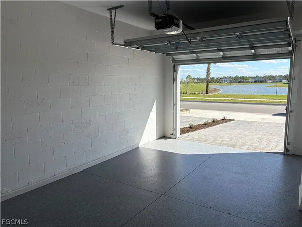 a view of a room with an empty space and a window