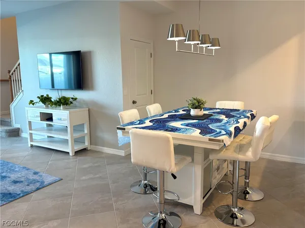 a view of a dining room with furniture and a chandelier
