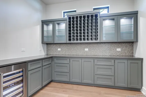 a kitchen with granite countertop a sink a stove and cabinets