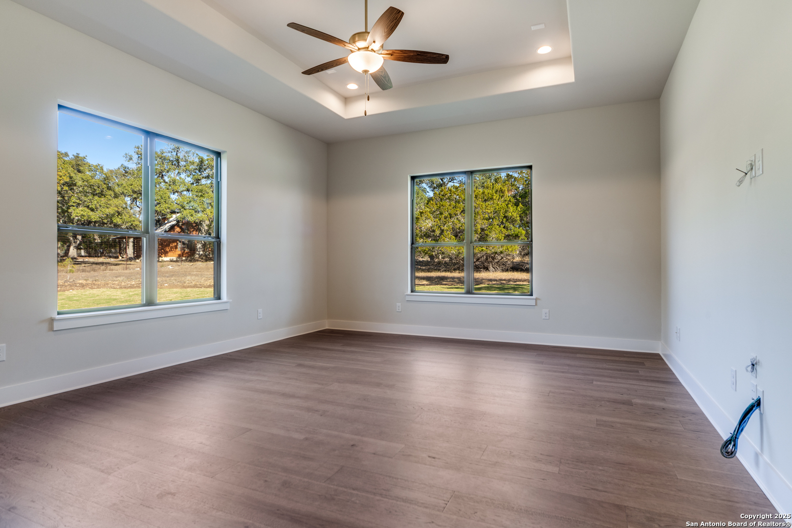 193 Ranch Heights Boerne, TX 78015 - Photo 22 of 29 a view of an empty room with window and wooden floor