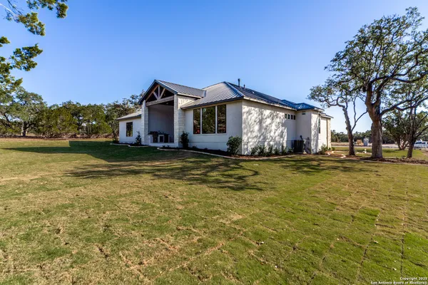 an aerial view of a house with a yard and lake view
