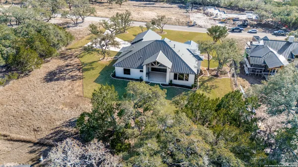 an aerial view of a house with a yard