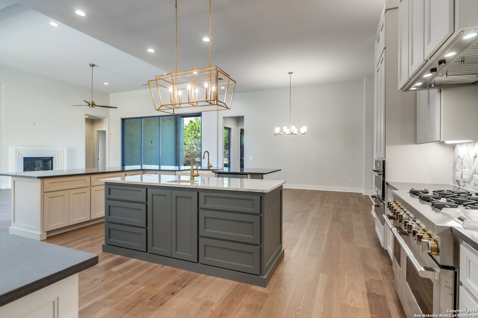 193 Ranch Heights Boerne, TX 78015 - Photo 9 of 29 a kitchen with stainless steel appliances granite countertop a sink a stove and a wooden floors