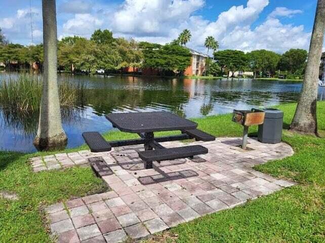 4159 Haverhill Road, Unit 1307 West Palm Beach, FL 33417 - Photo 12 of 14 a view of a lake with a yard and a garden