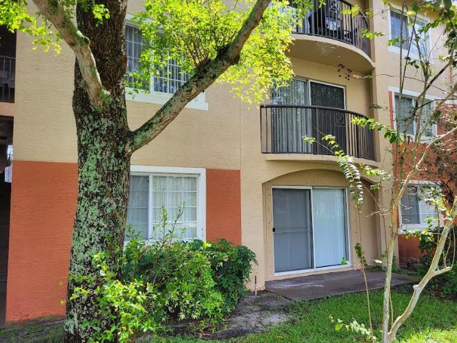4159 Haverhill Road, Unit 1307 West Palm Beach, FL 33417 - Photo 2 of 14 a view of a house with a tree