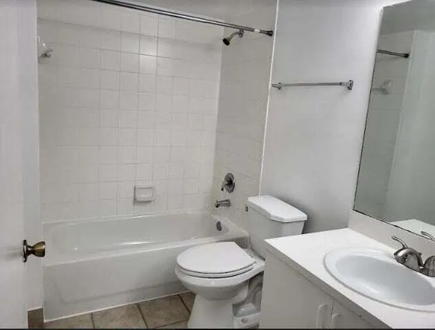 a bathroom with a toilet sink and shower