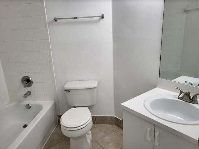 4159 Haverhill Road, Unit 1307 West Palm Beach, FL 33417 - Photo 8 of 14 a bathroom with a sink toilet and shower