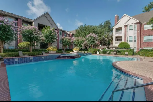 a front view of a house with swimming pool having outdoor seating