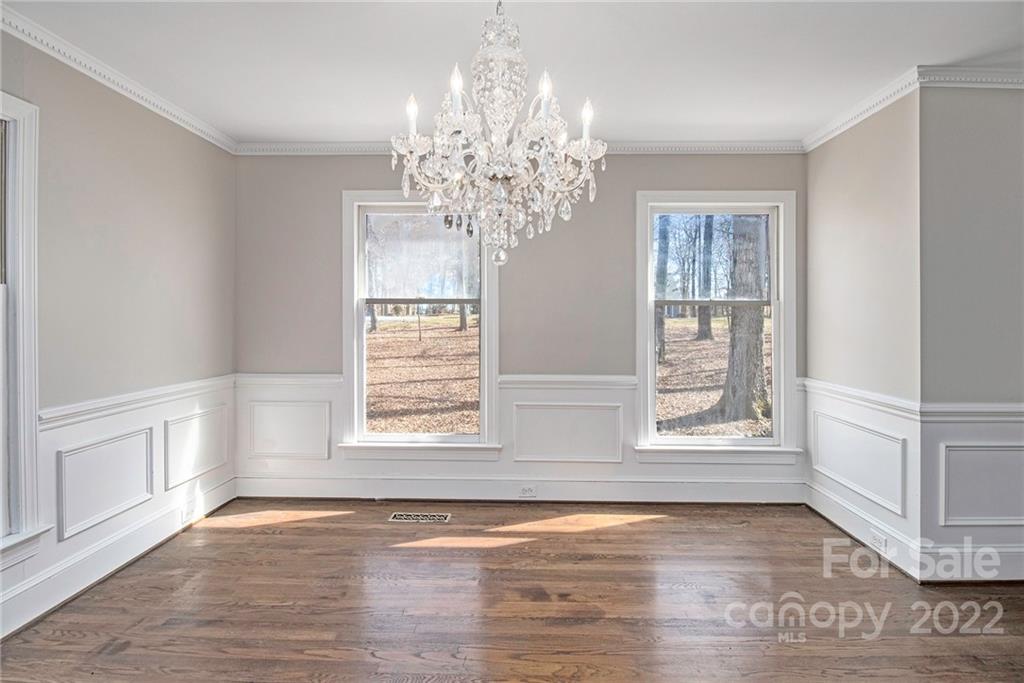 5130 Panhandle Circle Matthews, NC 28104 - Photo 15 of 20 a view of an empty room with wooden floor and a window