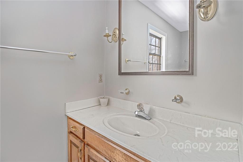 5130 Panhandle Circle Matthews, NC 28104 - Photo 16 of 20 a bathroom with a sink and a mirror