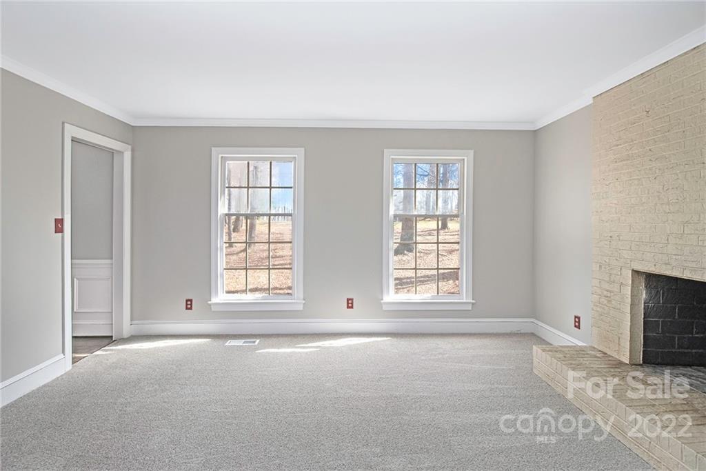 5130 Panhandle Circle Matthews, NC 28104 - Photo 3 of 20 an empty room with windows and fireplace