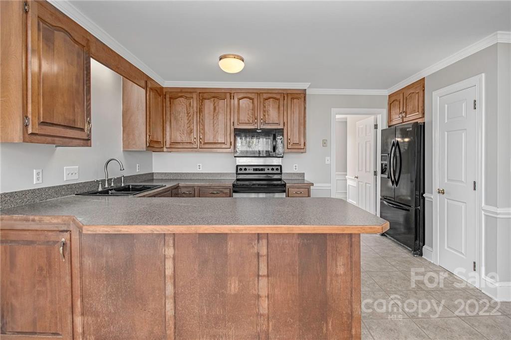 5130 Panhandle Circle Matthews, NC 28104 - Photo 7 of 20 a kitchen with a refrigerator and a sink