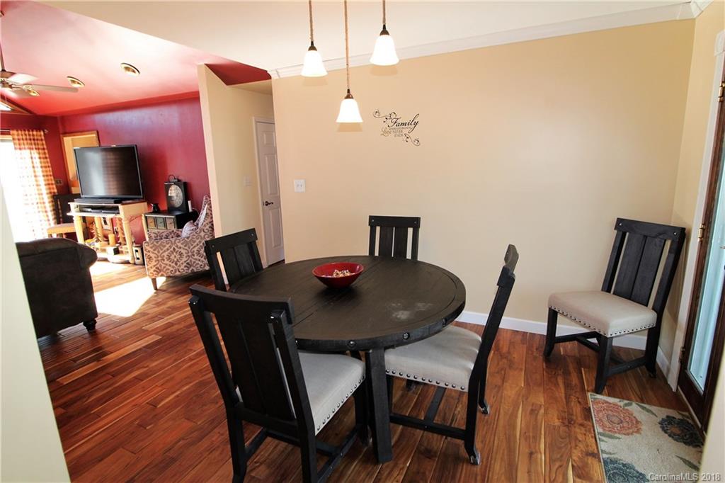 1930 Bobby Ray Road, Unit 10 Clover, SC 29710 - Photo 7 of 24 a view of a dining room with furniture and wooden floor
