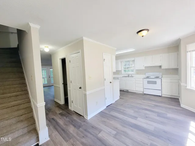 a view of a kitchen with wooden floor and electronic appliances