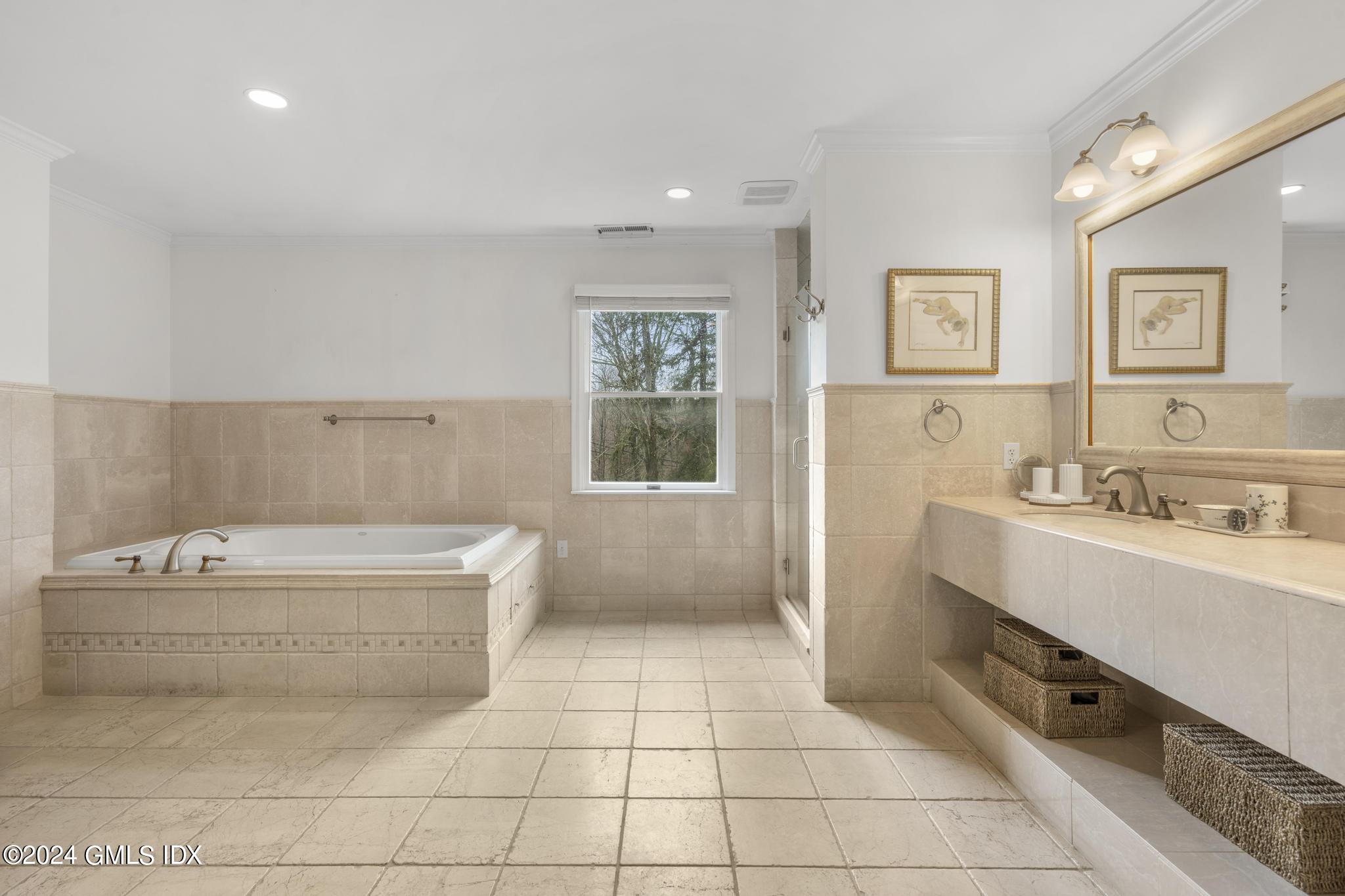 311 Cognewaugh Road Cos Cob, CT 06807 - Photo 12 of 28 a bathroom with a bathtub sink and mirror