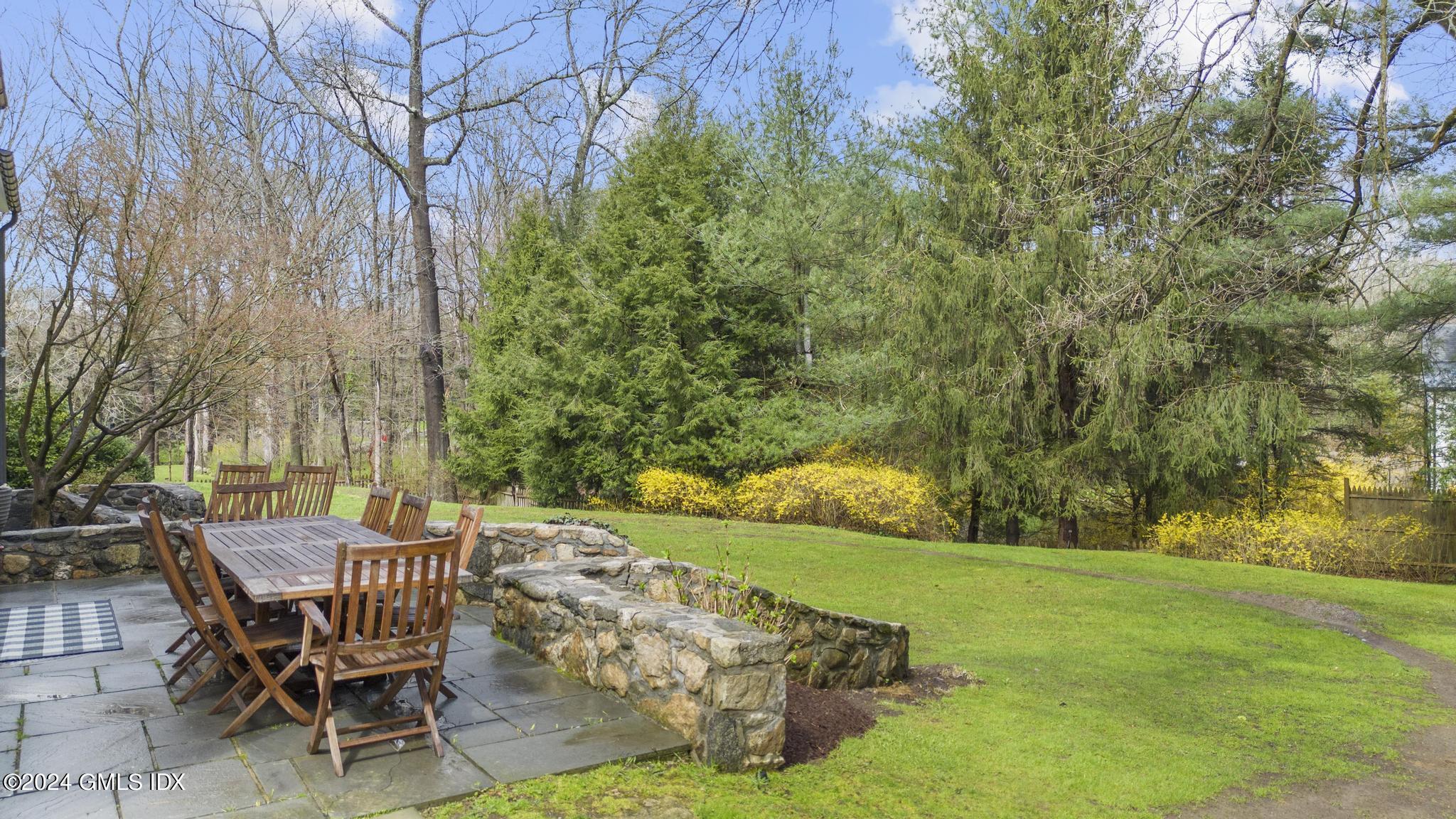311 Cognewaugh Road Cos Cob, CT 06807 - Photo 20 of 28 a view of a backyard with table and chairs and a slide