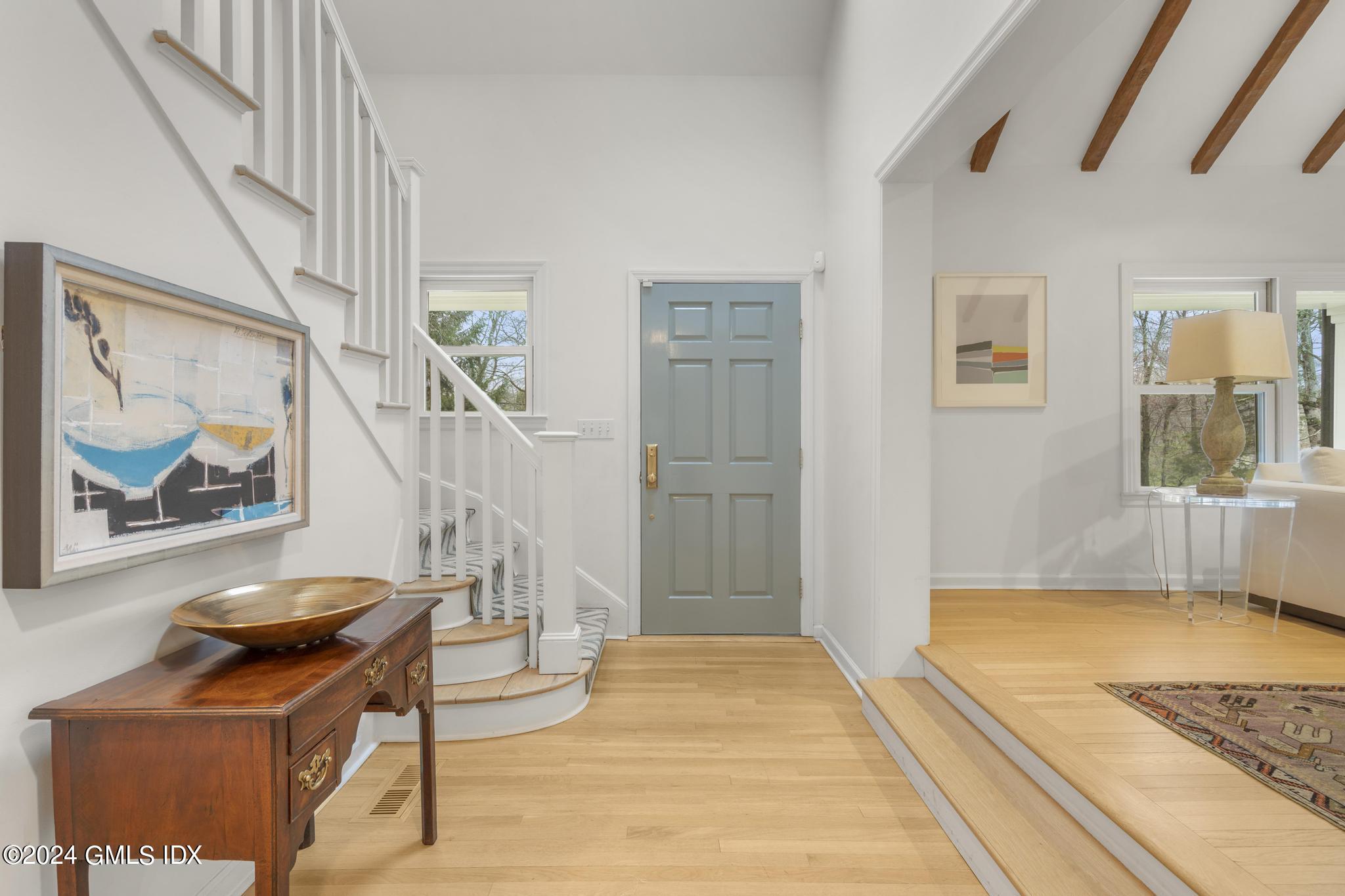 311 Cognewaugh Road Cos Cob, CT 06807 - Photo 2 of 28 a bedroom with a bed and a painting on the wall